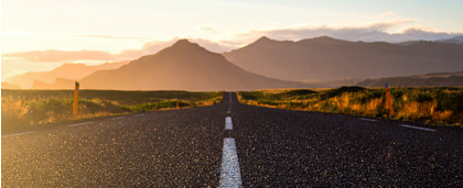 country road leading towards mountains