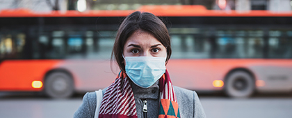 woman standing outside wearing face mask